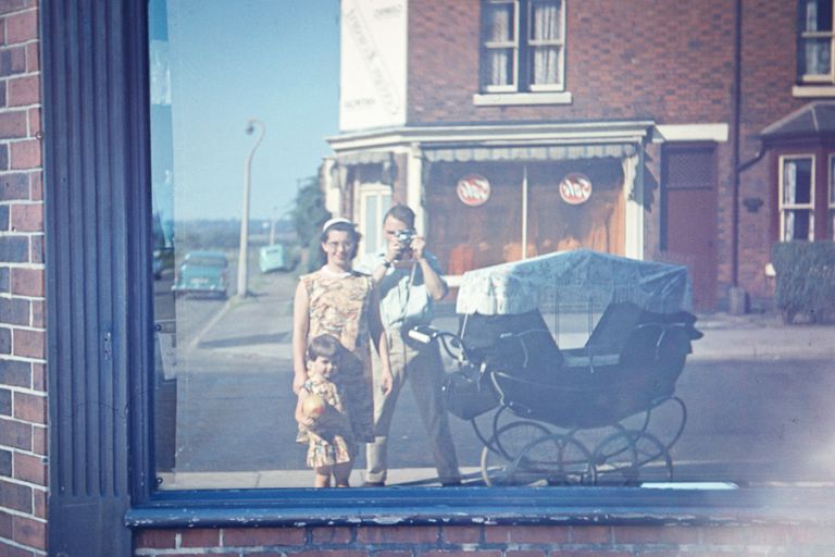 A family's reflection in a hop window 1963