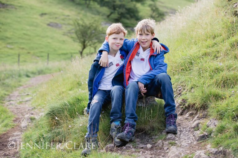 Photograph of two young brothers, in England rugby shirts, sitting on a rock in Dovedale, Derbyshire